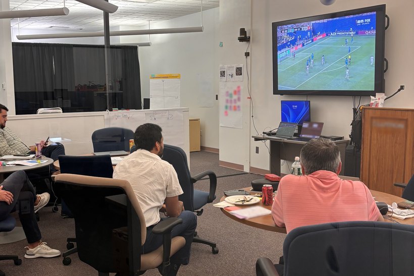 Workshop group watching the World Cup on a big screen during a break on day three